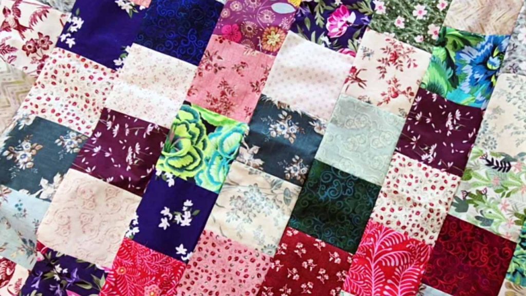 image of Scrappy Charm Square Baby Quilt for Beginners